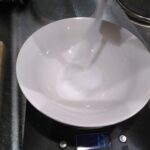 Pouring salt into a bowl